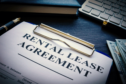 Rental lease agreement with pen on a desk.