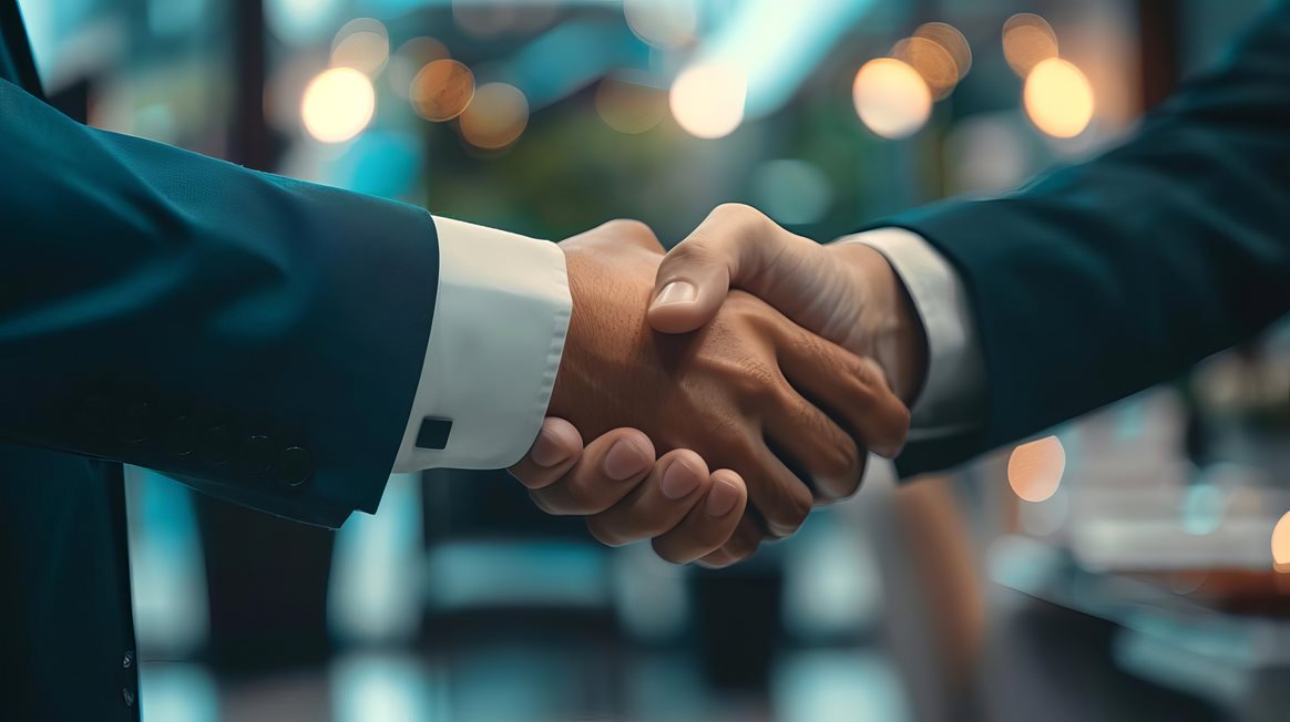 Business people negotiating and shaking hands in an office