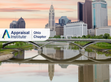 The image shows the downtown skyline of Columbus, Ohio, featuring the distinctive Main Street Bridge spanning the Scioto River with the Appraisal Institute Ohio Chapter Logo