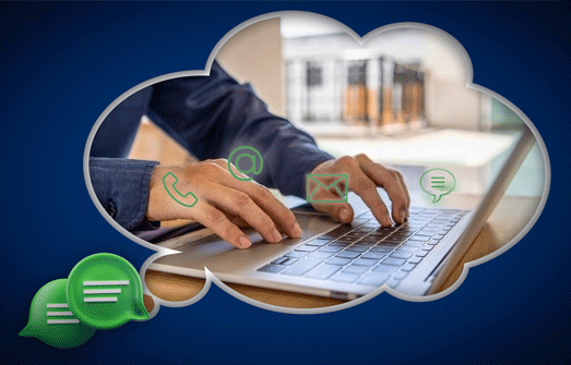 Dark blue bubble speech concept of an image of a person typing on a laptop with communication icons floating above the hands.