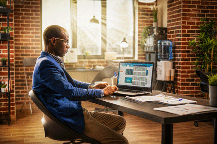 Professional working on a computer in a sunlight room.
